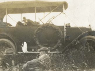 1913 - Men lounging in field near car