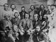 Councillors of the Provisional Government of the Métis Nation. Front row, L-R: Robert O'Lone, Paul Proulx. Centre row, L-R: Pierre Poitras, John Bruce, Louis Riel, John O'Donoghue, François Dauphinais. Back row, L-R: Bonnet Tromage, Pierre de Lorme, Thomas Bunn, Xavier Page, Baptiste Beauchemin, Baptiste Tournond, Joseph (Thomas?) Spence[1] This image is frequently listed with the caption that the persons in the photograph are councillors of the Provisional Government of the Métis Nation, however, there are several persons in the image who were not councillors in the Legislative Assembly, but did hold offices at different levels of the provisional government.