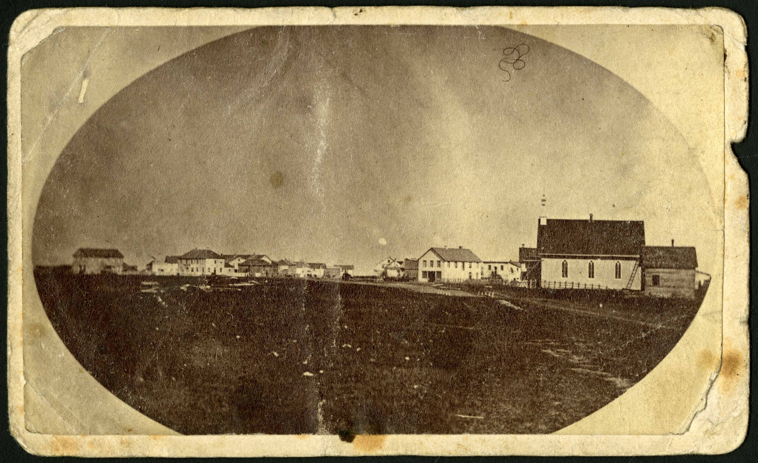 1871-Photograph of a muddy Main Street in 1871, facing northeast from around St. Mary Avenue