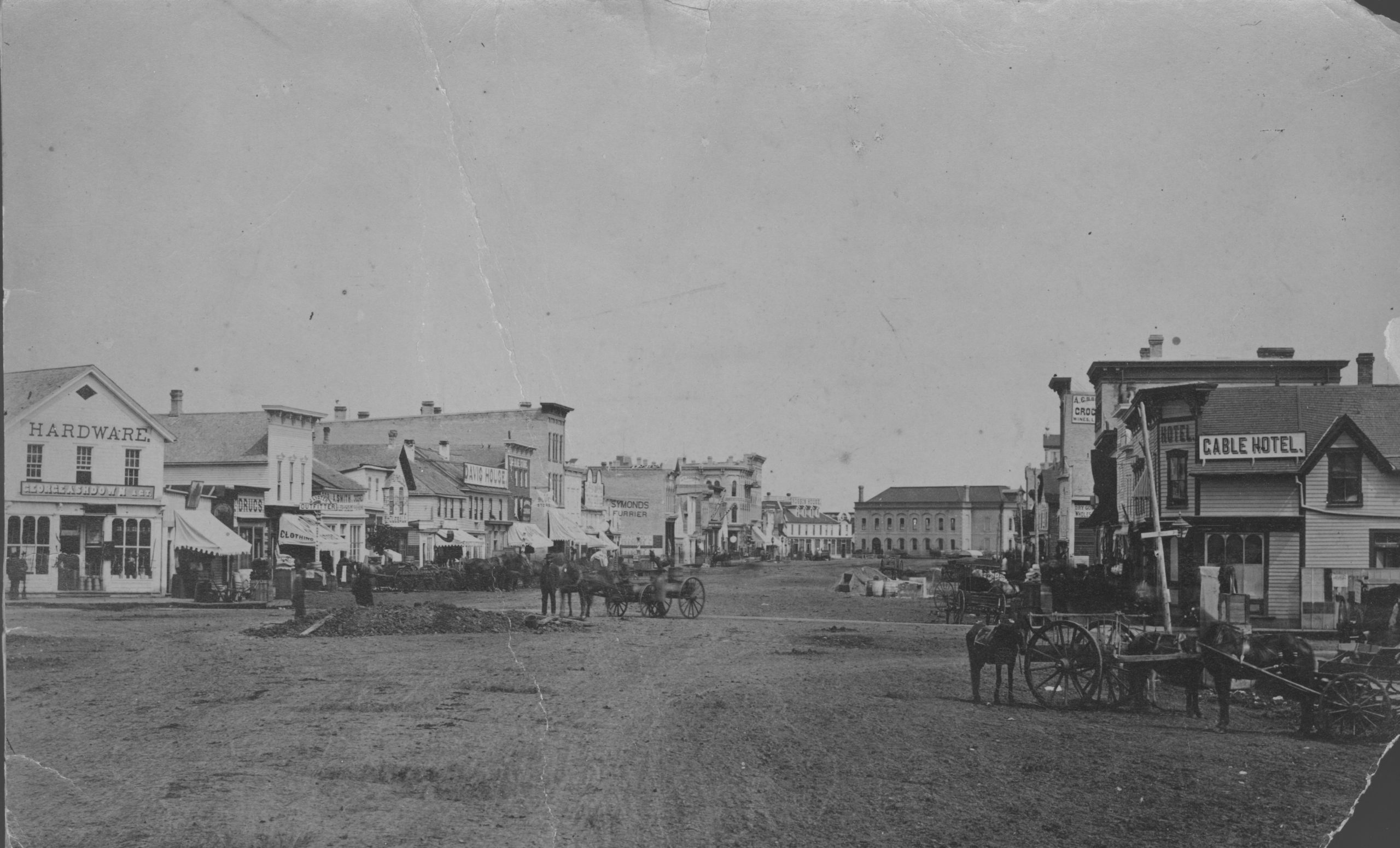 1883-City of Winnipeg businesses shown in photograph-George Ashdown Hardware, Davis House, Symonds Furrier, Gable Hotel, J. Lister, Outfitter, Rossin House, the Blue Store, and the first City Hall