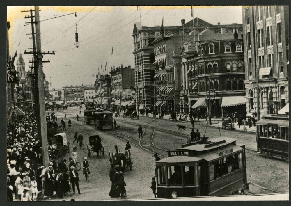 1905-Photograph shows four streetcars at Portage and Main after the installation of cedar-block pavement