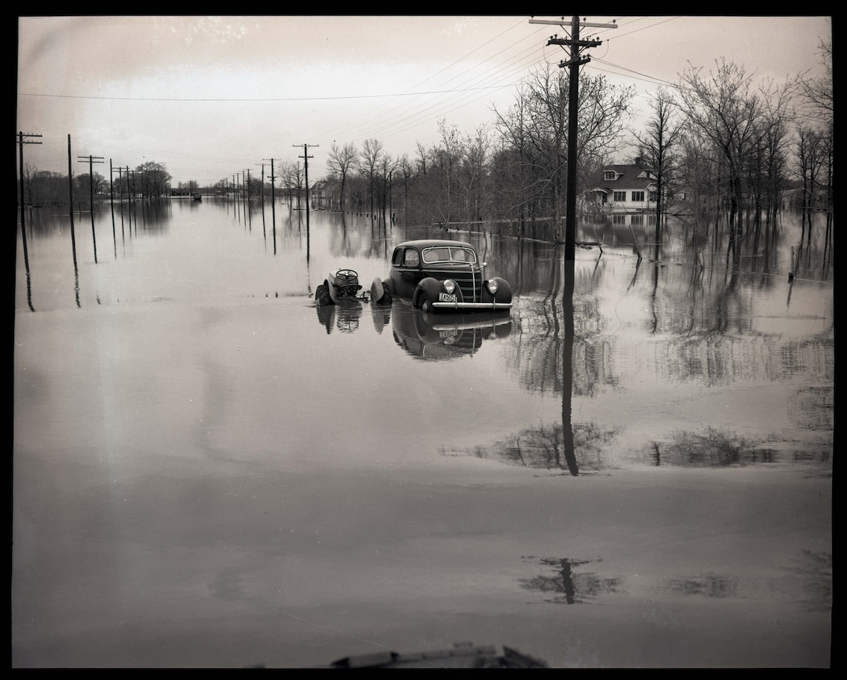 Car and tractor stuck in flood waters during the 1950 flood